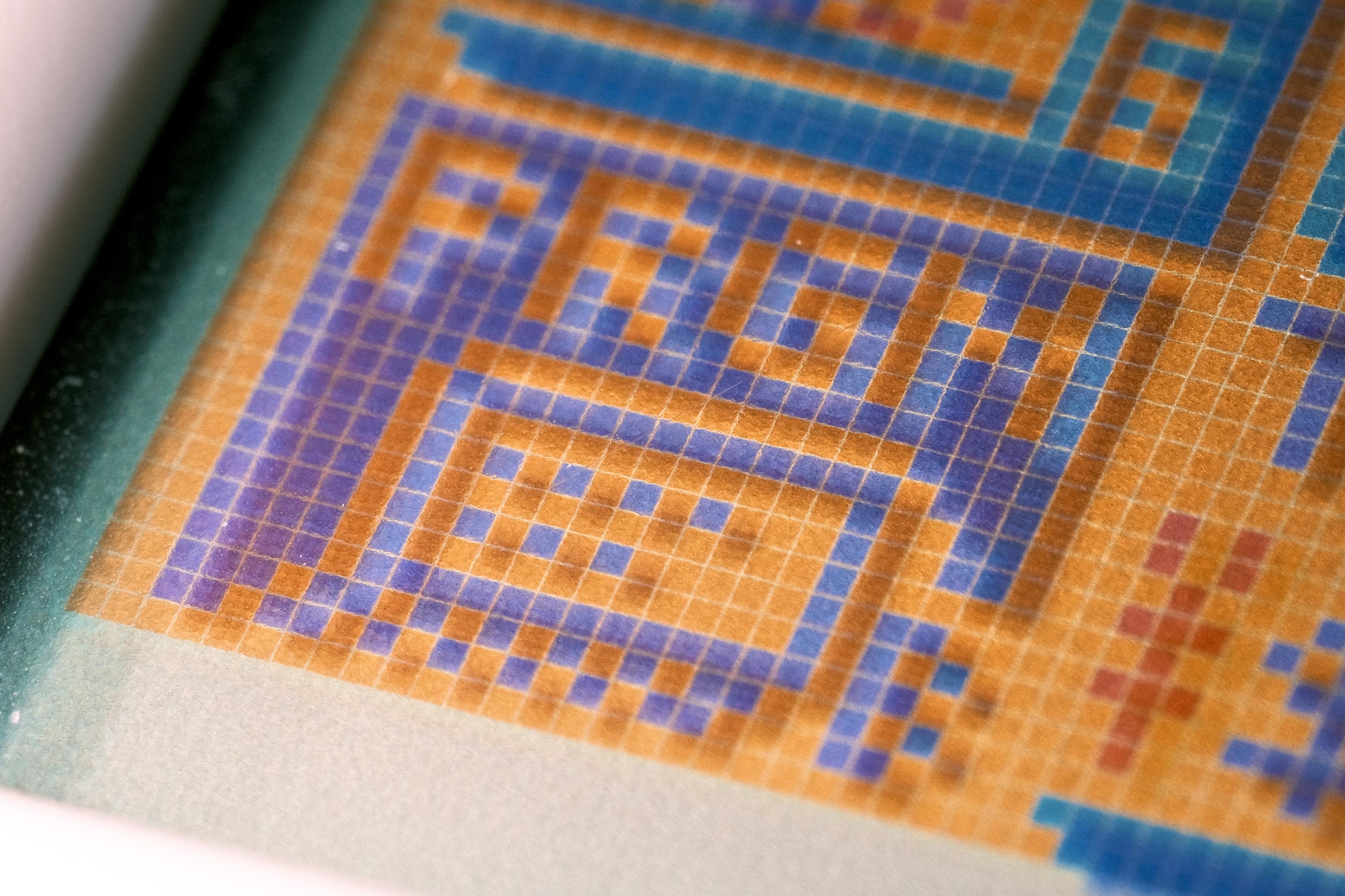 A photo of the same scene but zoomed out a little. Now the colours are inverted and everything is deep blue except for the orange computer